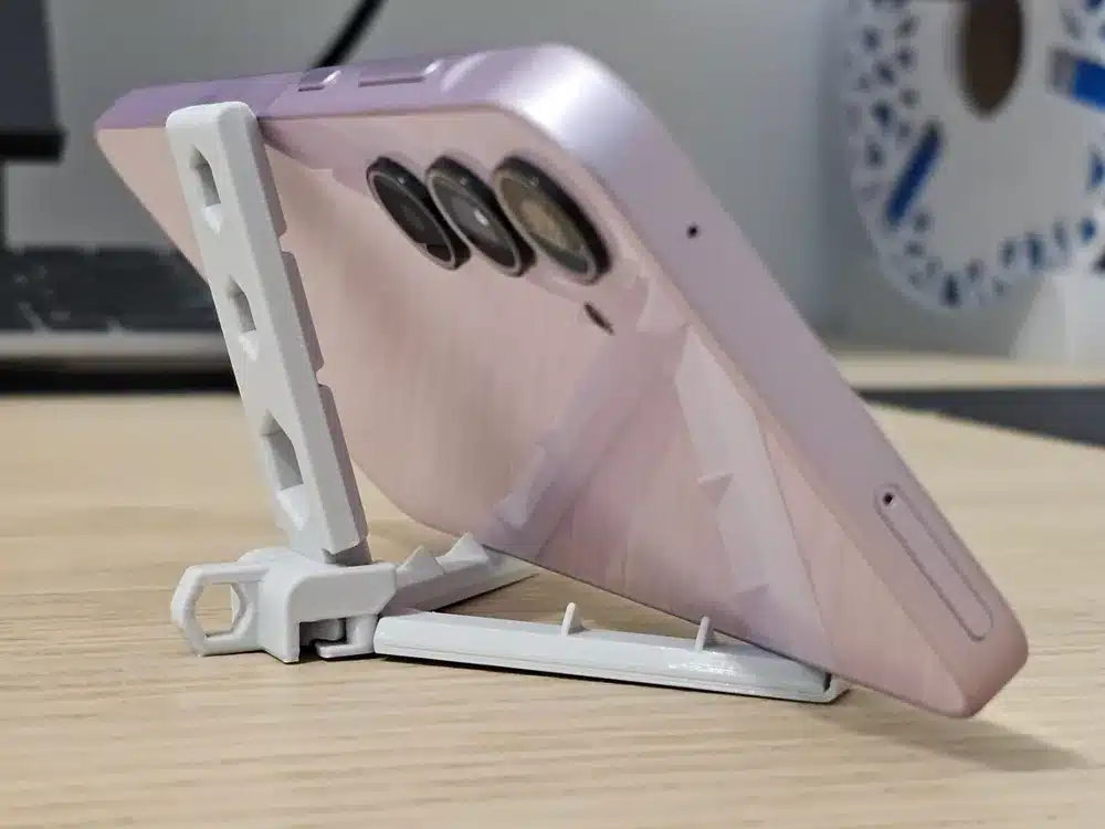Smartphone on adjustable stand, side view.
