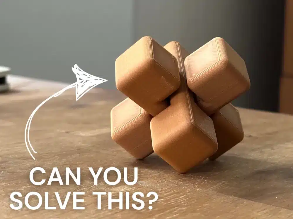Intricate 3D puzzle on wooden table with 'Can You Solve This?' text and arrow pointing to the challenge.