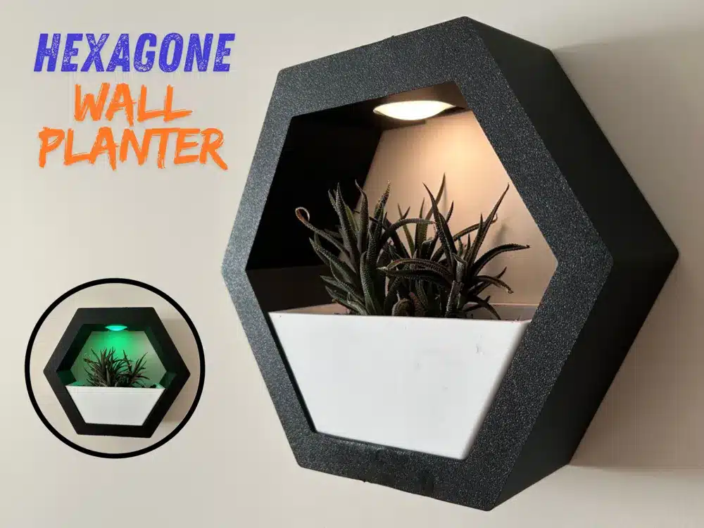 Hexagonal wall planter with integrated light, featuring a modern design and succulent plant for stylish home decor.