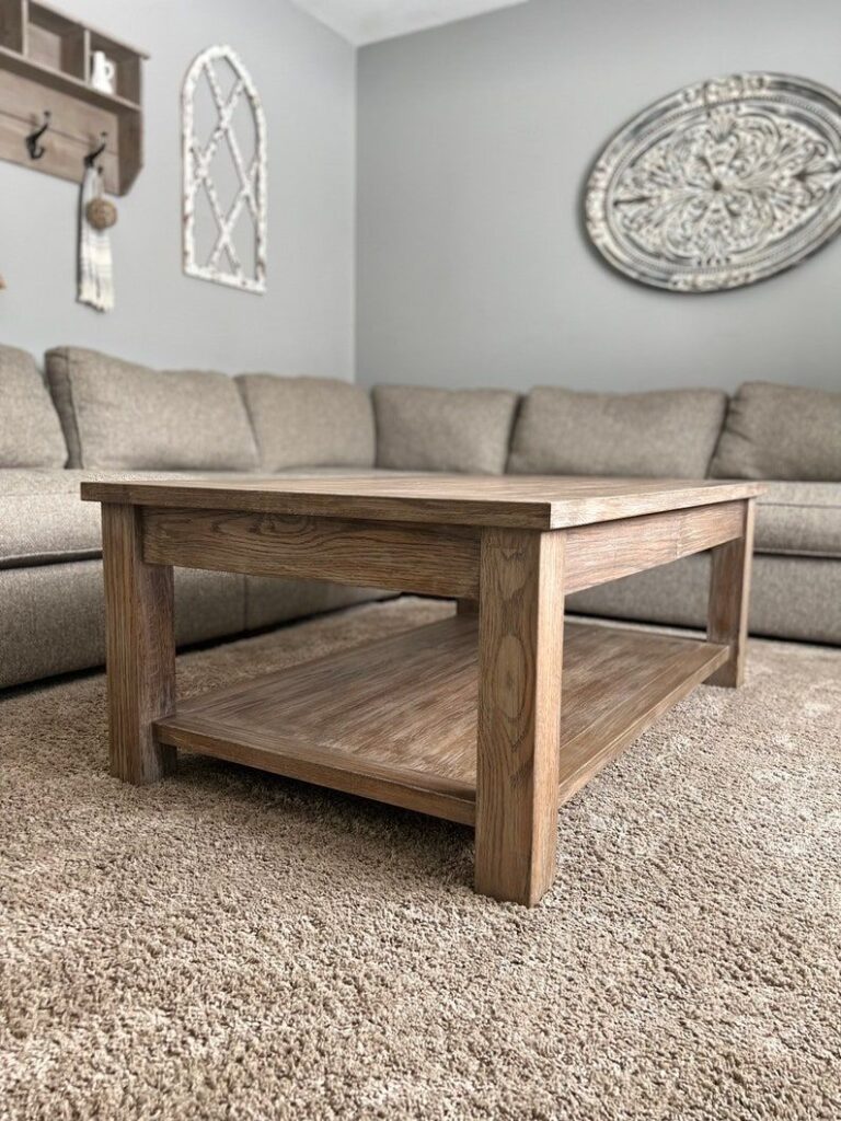 Rustic wooden coffee table in cozy living room with beige sofa and decorative wall art.
