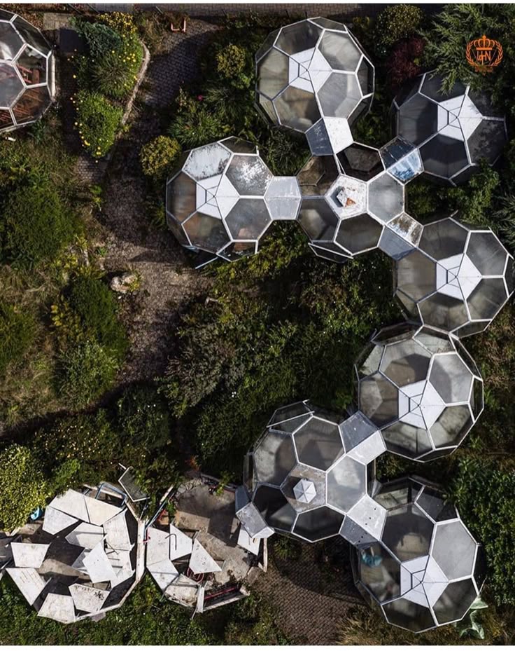 Aerial view of futuristic geodesic domes surrounded by lush greenery and pathways.