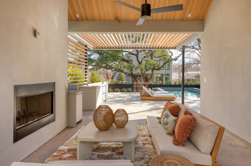 2206-S-3rd-St-039jpg-FULLJPG-vsuniqueid-66d942194676b Modern outdoor patio with cozy seating, fireplace, and pool view under a pergola roof. | Sky Rye Design Modern outdoor patio with cozy seating, fireplace, and pool view under a pergola roof.