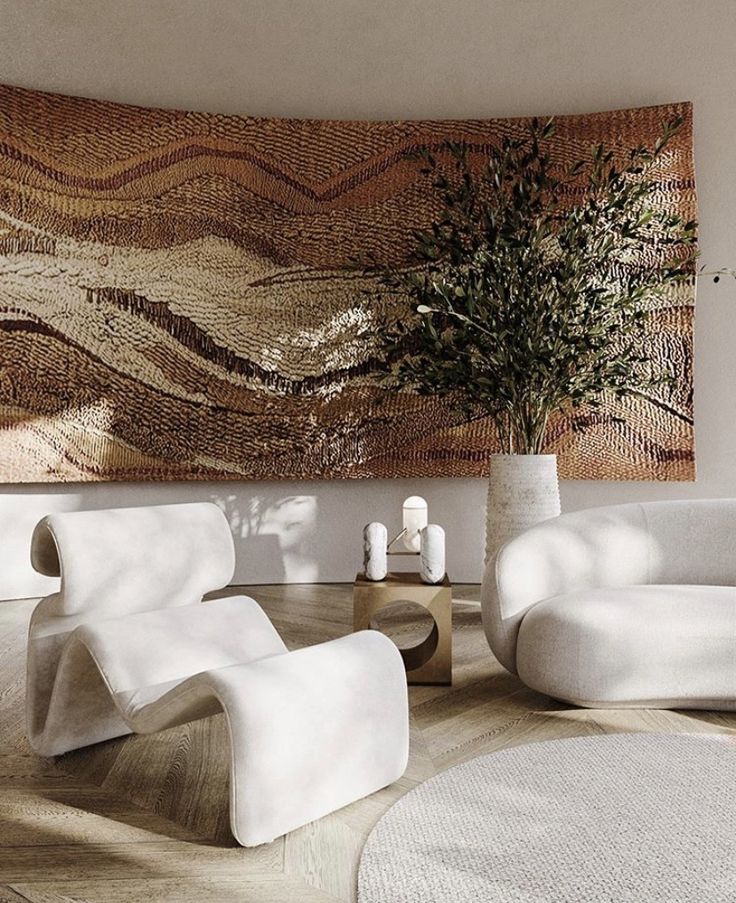 Minimalist living room with sculptural white chairs, abstract wall art, and a large plant in a neutral-toned setting.
