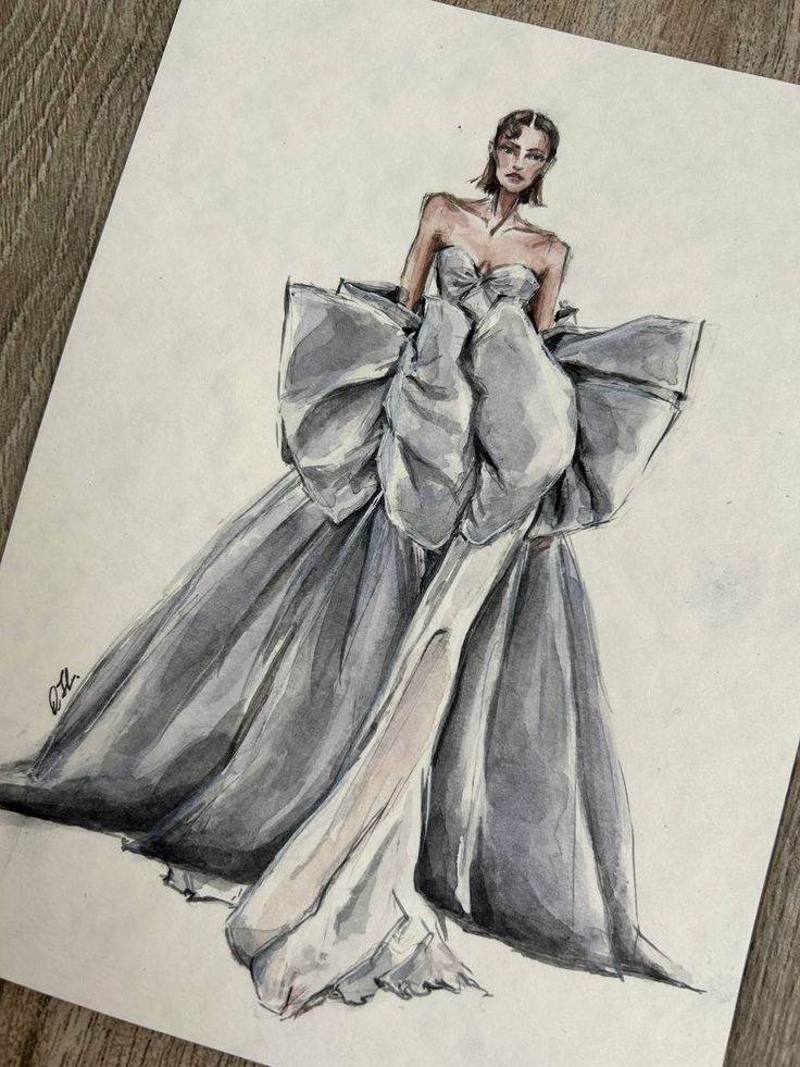 Fashion illustration of a woman in a dramatic gray gown with oversized bow details on a wooden surface.