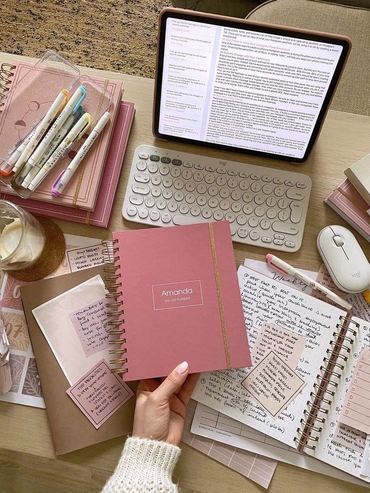 Cozy workspace with notebooks, keyboard, and tablet for productive study and planning sessions.
