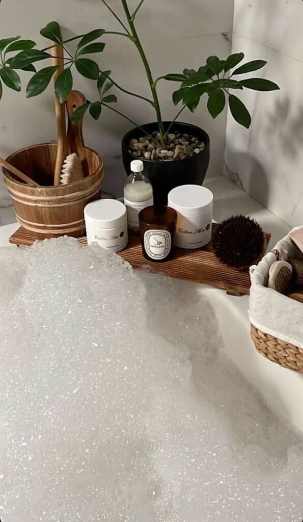 _ 3 Luxurious bath setup with bubbles, spa products, and a potted plant for a relaxing home spa experience. | Sky Rye Design Luxurious bath setup with bubbles, spa products, and a potted plant for a relaxing home spa experience.