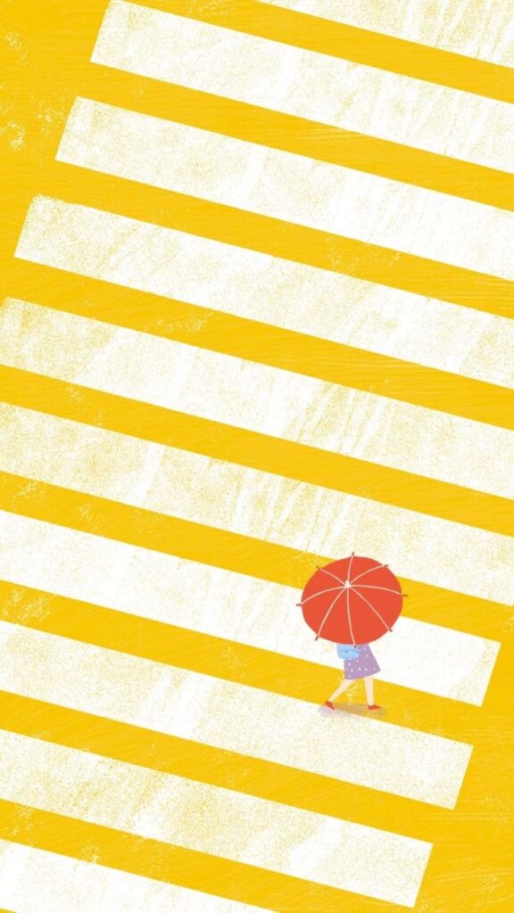 Person with red umbrella crossing colorful yellow stripes, overhead view.