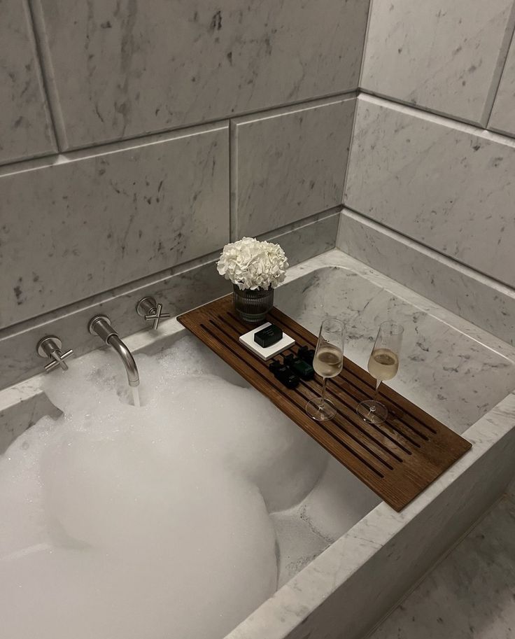 _ 4 Luxurious marble bath with wooden tray, flowers, and champagne glasses, perfect for a relaxing spa experience. | Sky Rye Design Luxurious marble bath with wooden tray, flowers, and champagne glasses, perfect for a relaxing spa experience.