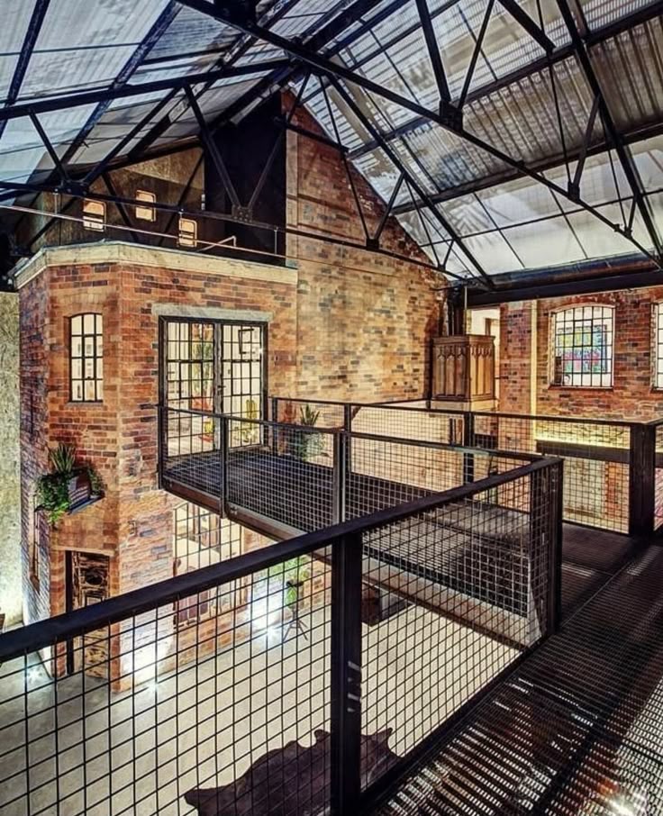 Industrial loft with exposed brick walls, metal beams, and modern mezzanine. Unique urban interior design space.