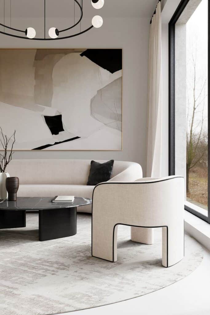 Modern living room with minimalist decor, abstract painting, chic furniture, and large window view.