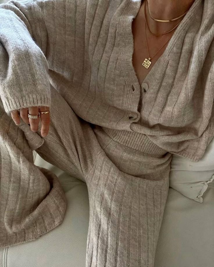 Cozy ribbed knitwear outfit with gold jewelry detail for elegant, comfortable style.