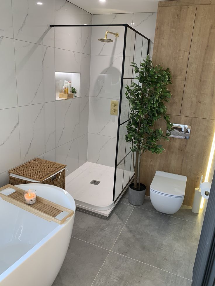 Modern bathroom with a glass shower, freestanding tub, and wooden accents for a sleek spa-like design.