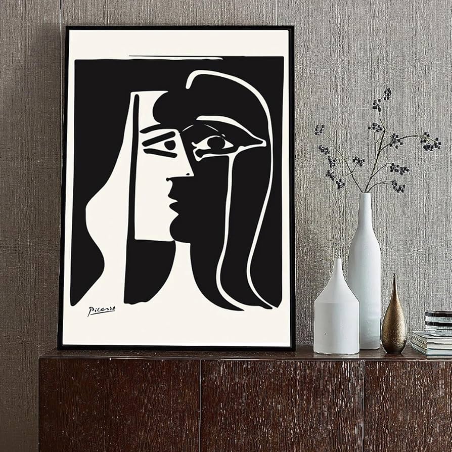 Abstract black and white painting with geometric face shapes on a minimalist shelf with vases.