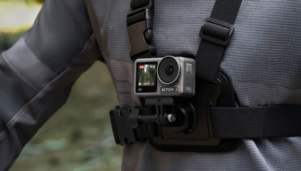 Action camera mounted on a chest harness for hands-free adventure recording in outdoor settings.