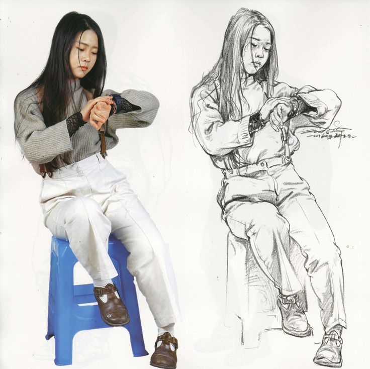 Woman sitting on stool with drawing, adjusting watch, wearing gray sweater and white pants, next to a detailed sketch.