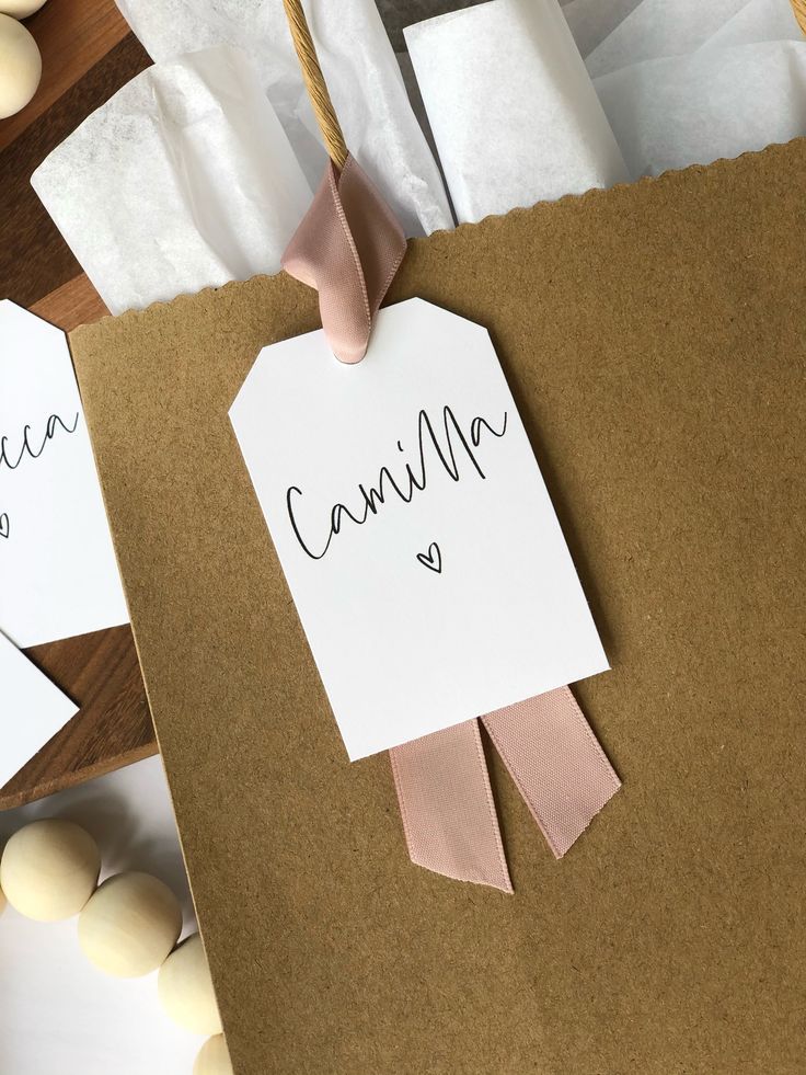 Gift bag with a handwritten tag, elegant ribbon, and rustic paper, perfect for personalized or party gifting.