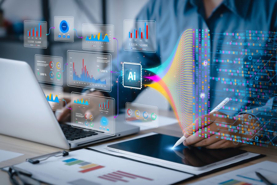 Person using AI technology for data analysis with laptop and tablet, featuring colorful infographics and digital interface.