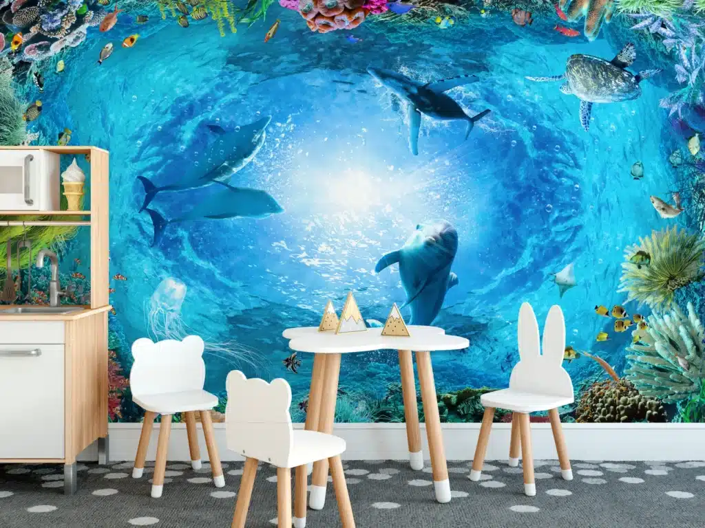 B236underwatercoralreeflandscapebackgroundinthedeepblueoceanwithcolorfulfish_87 Children's room with playful ocean-themed mural and cute animal chairs, featuring sharks, turtles, and colorful fish. | Sky Rye Design Children's room with playful ocean-themed mural and cute animal chairs, featuring sharks, turtles, and colorful fish.