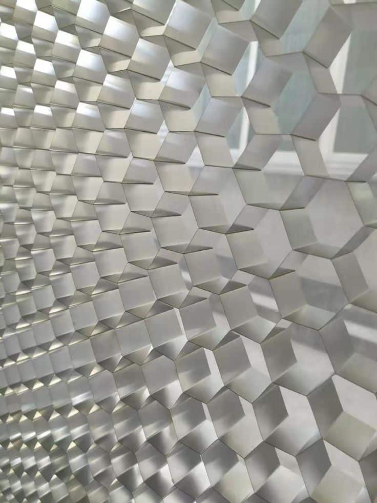 Geometric 3D panel design with a silver hexagonal pattern creating a modern, textured surface.