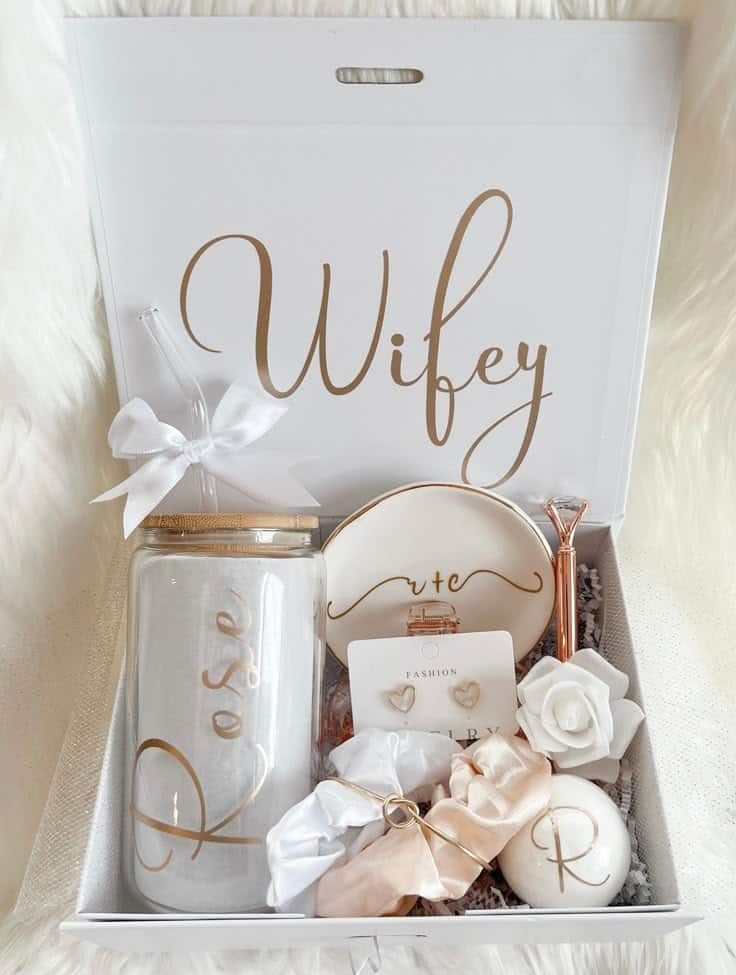 Bridal gift box with Wifey script, featuring a rose candle, scrunchies, heart earrings, and elegant accessories.