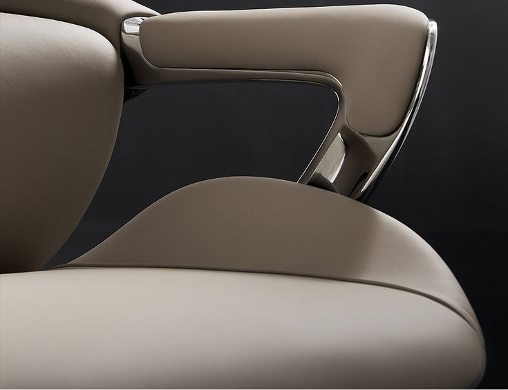 Buy MEDELIN Amundsen Luxurious Ergonomic Leather Office Chair Online _ maija Modern office chair armrest detail with sleek chrome and beige design against a dark background. | Sky Rye Design Modern office chair armrest detail with sleek chrome and beige design against a dark background.