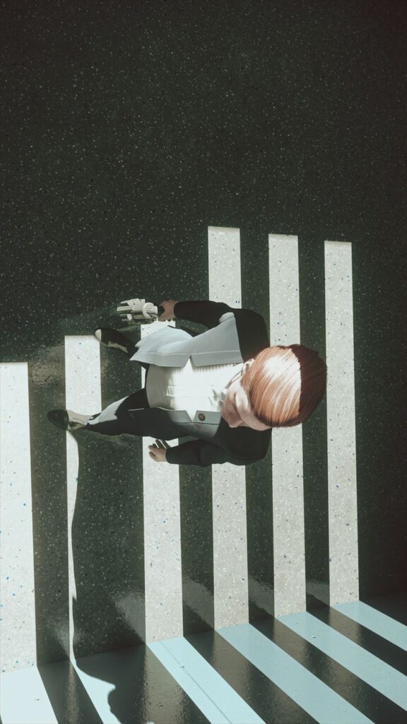 Person in suit walking across striped ground, casting shadows in sunlight. Aerial perspective focused on patterns.