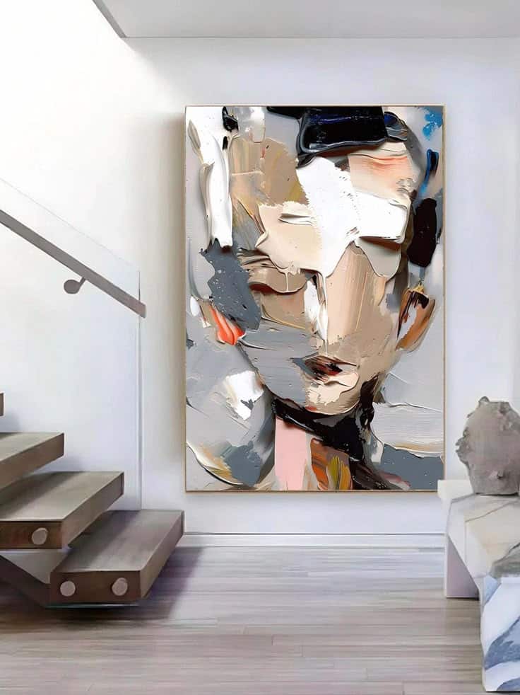 Abstract oil painting displayed in modern interior near stairs, featuring bold, textured brushstrokes in earthy tones.