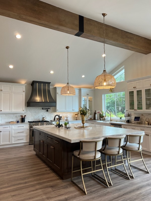 CopperSmith-SX5-Copper-Range-Hood-018 Spacious modern kitchen with large island, pendant lights, white cabinets, and wooden beam ceiling. | Sky Rye Design Spacious modern kitchen with large island, pendant lights, white cabinets, and wooden beam ceiling.