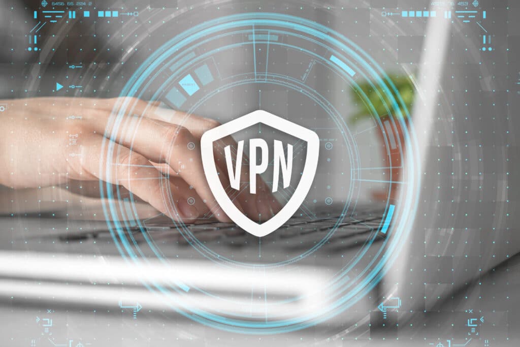 Depositphotos_564043322_XL Hands typing on a laptop with a digital VPN shield icon overlay, signifying online security and privacy. | Sky Rye Design Hands typing on a laptop with a digital VPN shield icon overlay, signifying online security and privacy.