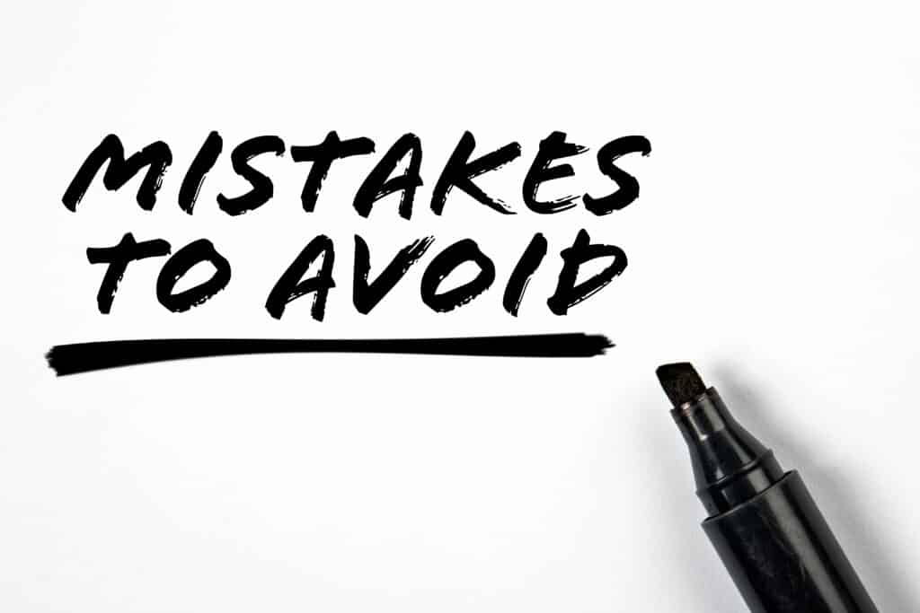 Text 'Mistakes to Avoid' with underline, written with a black marker on white background.