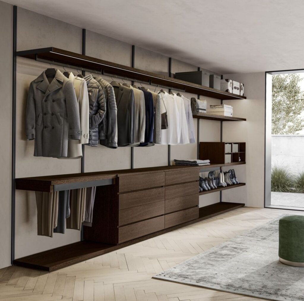 Modern walk-in closet with hanging clothes, wooden shelves, and drawers, showcasing organized storage solutions.