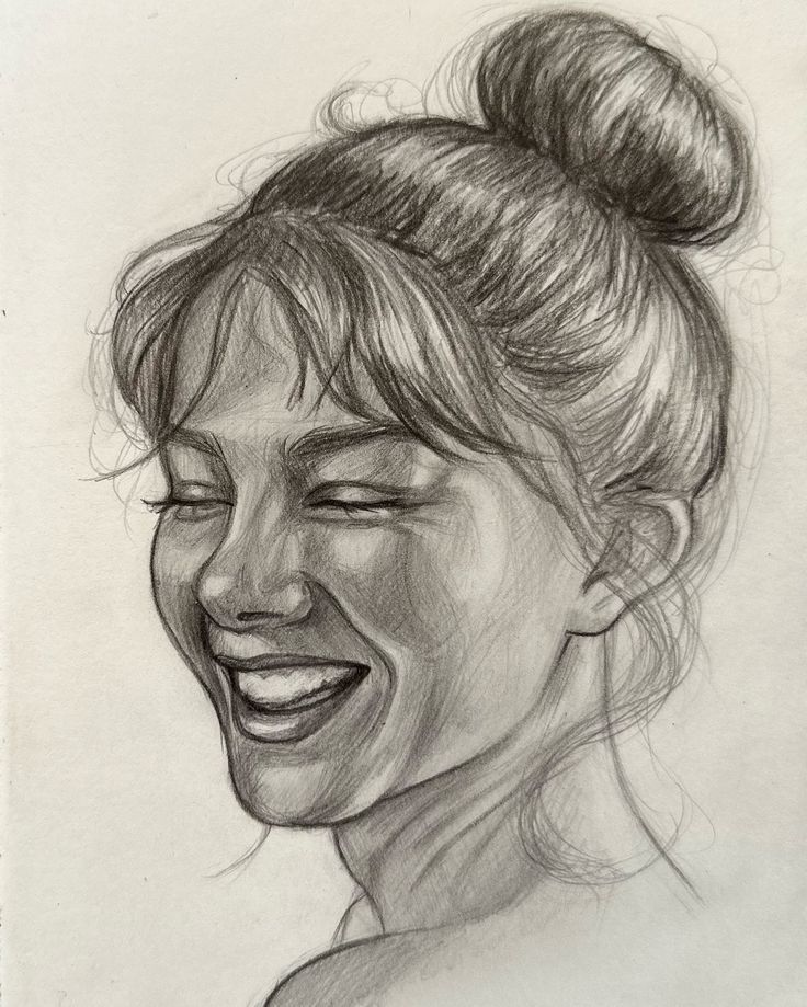 Pencil sketch of a woman smiling with hair in a bun, showcasing detailed shading and expressive features.