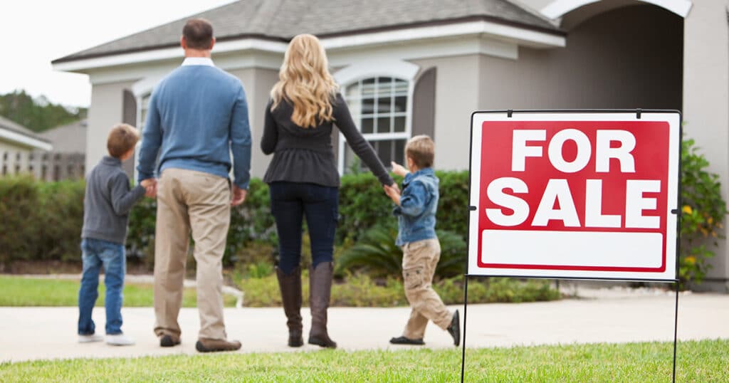 Essential Steps to Sell Your Home Photo Family viewing a house with a For Sale sign in front yard, considering buying a new home. | Sky Rye Design Family viewing a house with a For Sale sign in front yard, considering buying a new home.