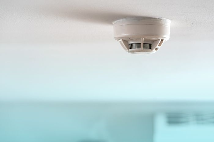 Smoke detector mounted on a ceiling, ensuring home safety and fire prevention.