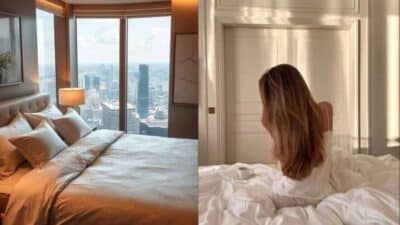 Luxurious bedroom with city view and woman relaxing on bed, bathed in warm morning light.