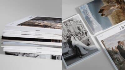 Stack of personalized wedding photo albums with elegant covers and couple portraits.