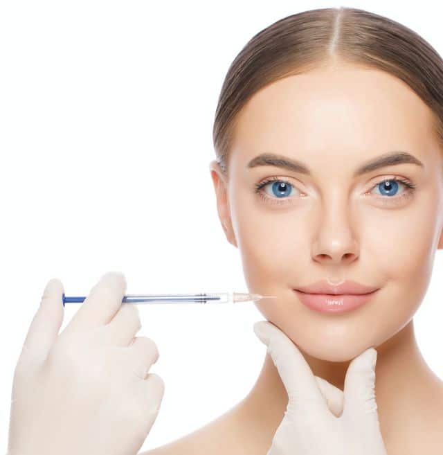 Woman receives cosmetic injection for facial enhancement, emphasizing skincare and aesthetic treatment.