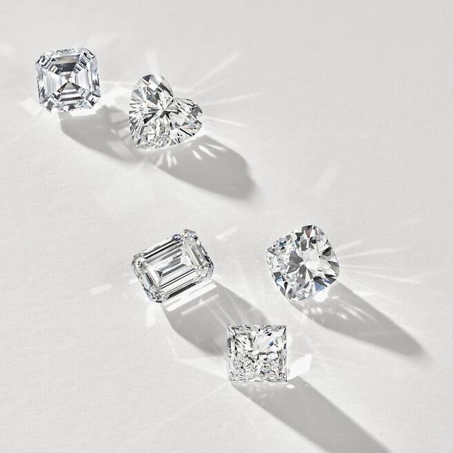 Assorted diamond shapes casting shadows on a white background.