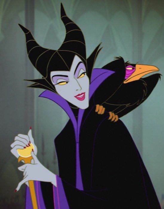 Animated character with horns and crow on shoulder, holding a staff, wearing a black and purple cloak, smiles slyly.