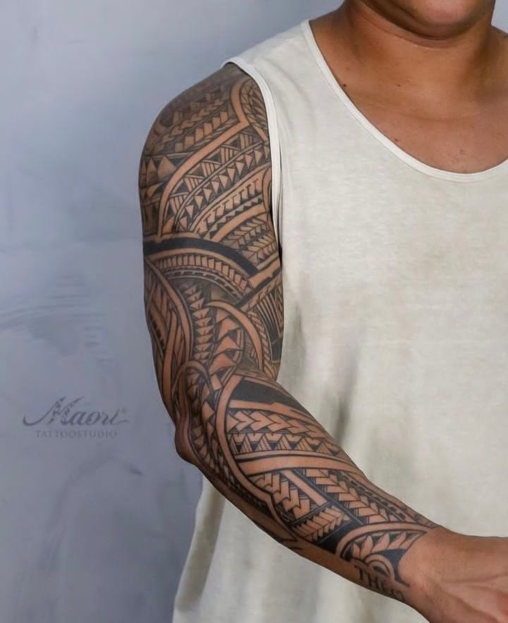 Maori tattoo ⚡ Intricate tribal sleeve tattoo on a man's arm, showcasing bold geometric patterns and designs. | Sky Rye Design Intricate tribal sleeve tattoo on a man's arm, showcasing bold geometric patterns and designs.