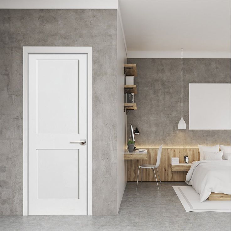 Modern bedroom with gray walls, white door, cozy bed, wood accents, and minimalist desk space.
