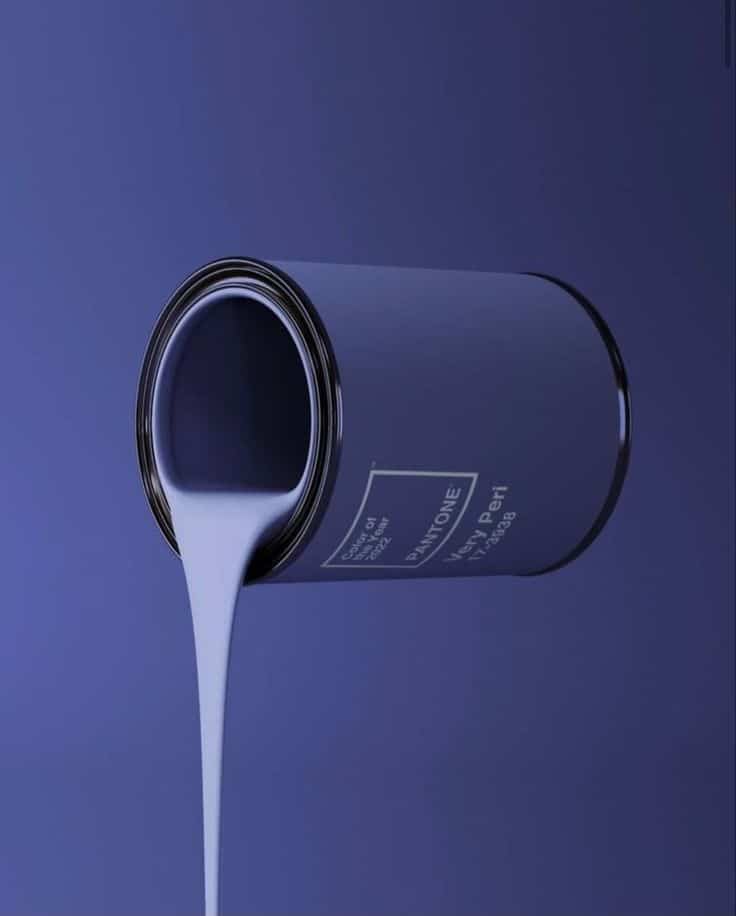 Paint can pouring lilac paint on blue background, labeled Pantone Very Peri, color of the year 2023.
