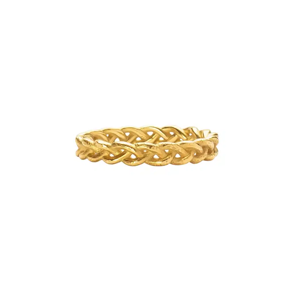 Elegant woven gold ring on a white background, showcasing intricate braided craftsmanship and luxurious design.