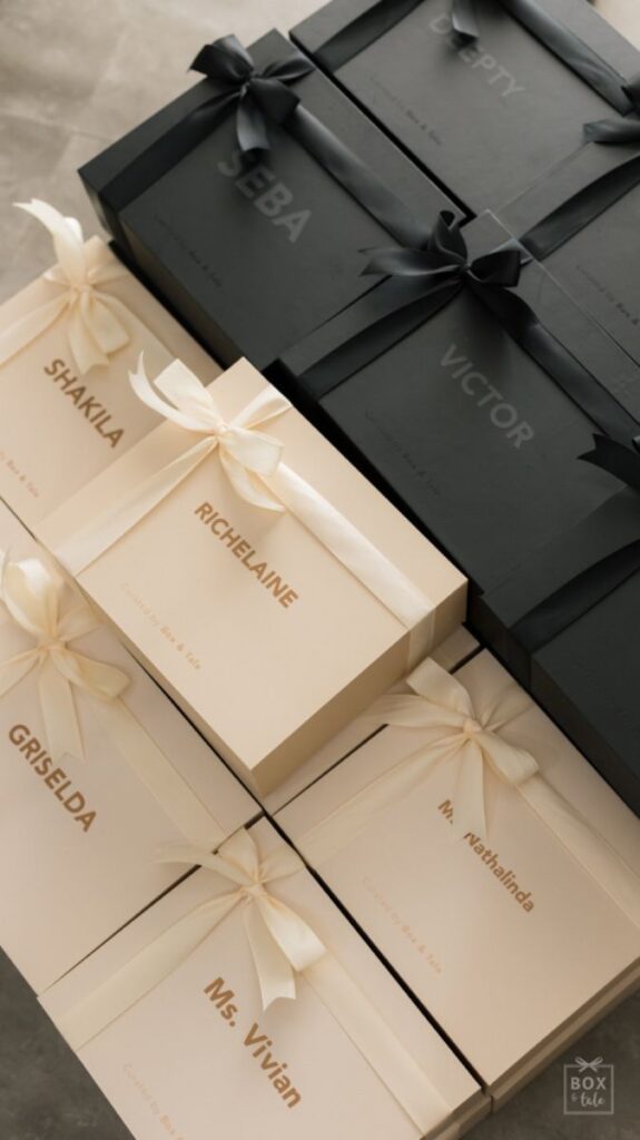 Elegant gift boxes with personalized names and ribbons, displaying luxury and style for special occasions.