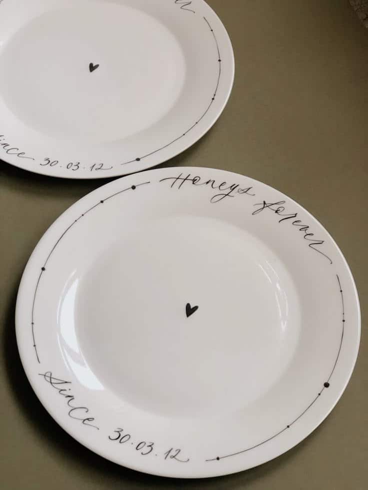 Decorative plates with heart design and script text saying since 30.03.12 and honestly forever in black.