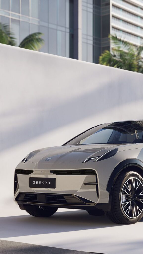 Futuristic Zeekr X electric car parked against modern city backdrop, showcasing sleek design and cutting-edge technology.