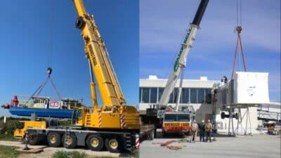 Two large cranes lifting heavy equipment on a clear day, showcasing industrial machinery and logistics.