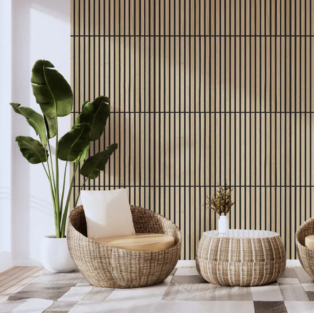 Modern sitting area with rattan chairs, striped wood wall, and potted plant for a stylish, natural decor.