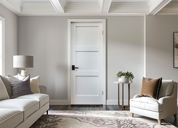 Elegant living room with white door, gray walls, cozy furniture, and stylish decor, enhancing modern interior design.