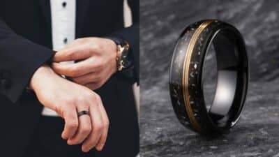 Close-up of a man adjusting a suit cuff with a black ring on hand, alongside a black ring with gold detailing.